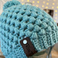 Light blue-green pom pom beanie