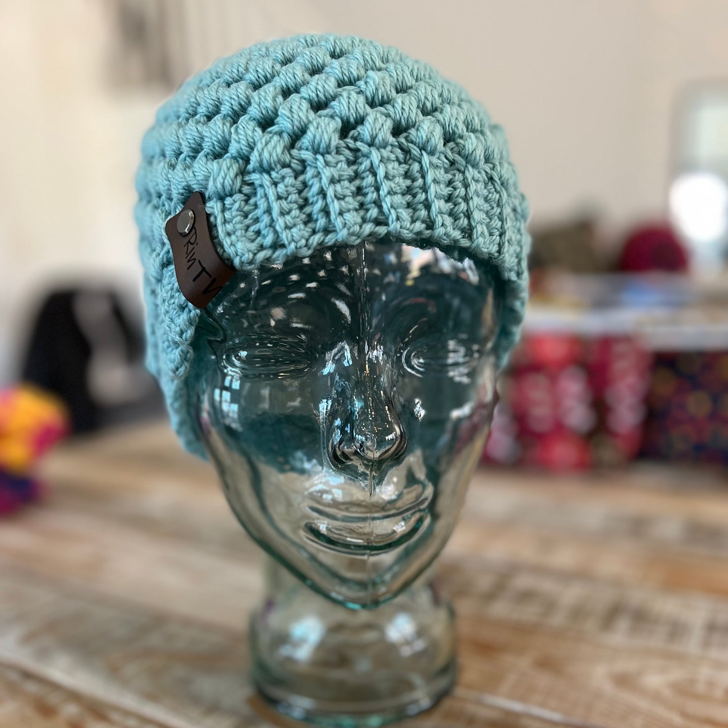 Light blue-green pom pom beanie