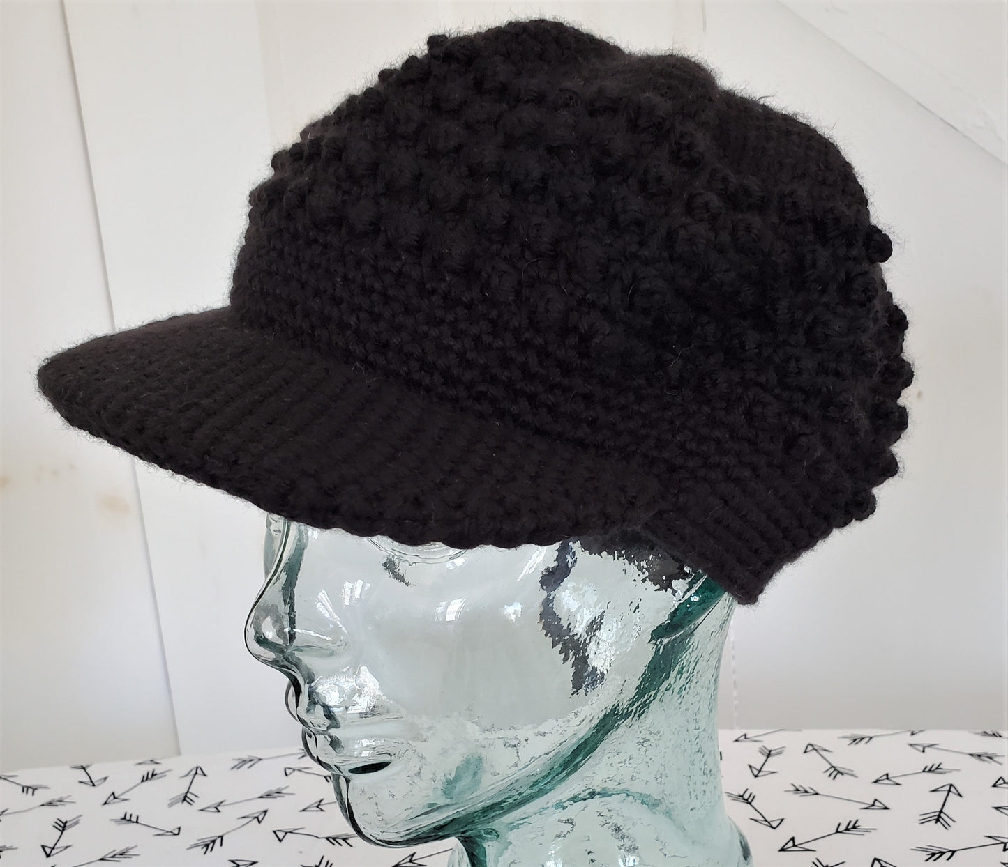 Black popcorn stitch cap with brim and toggle