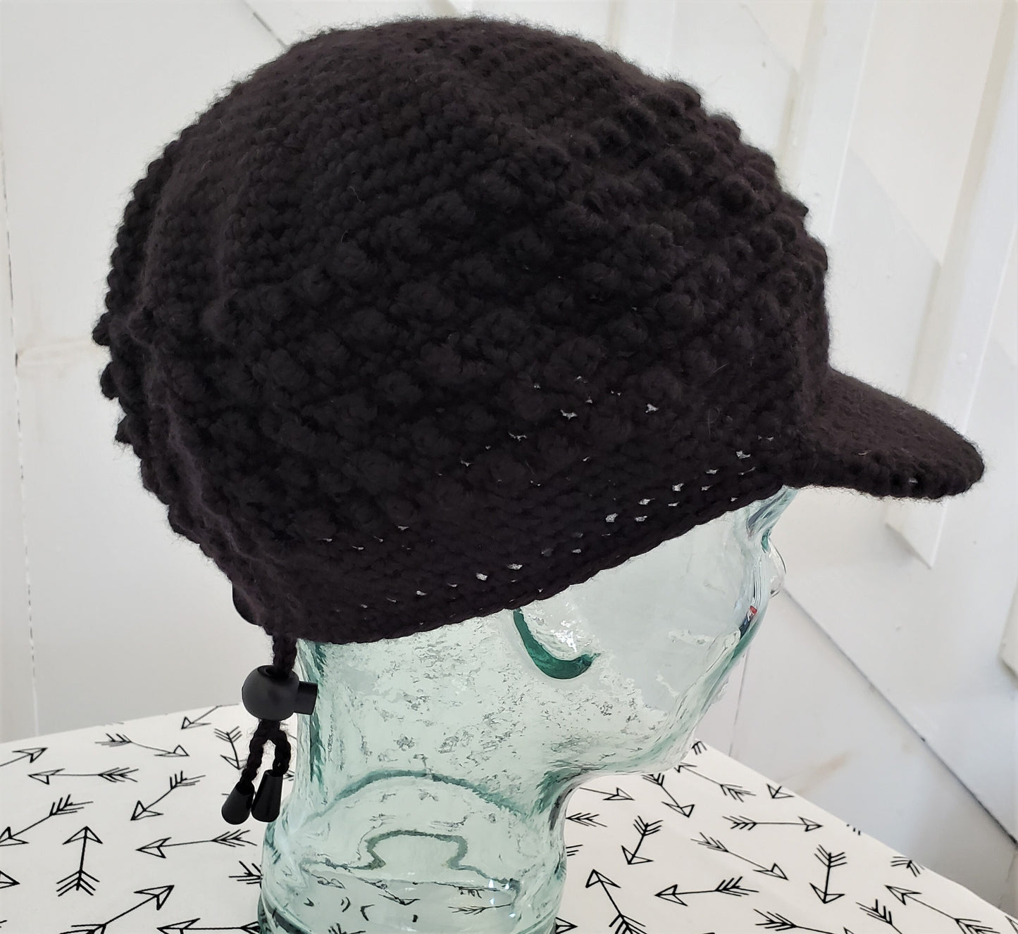 Black popcorn stitch cap with brim and toggle