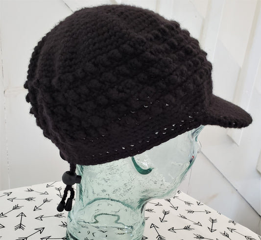 Black popcorn stitch cap with brim and toggle