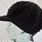 Black popcorn stitch cap with brim and toggle