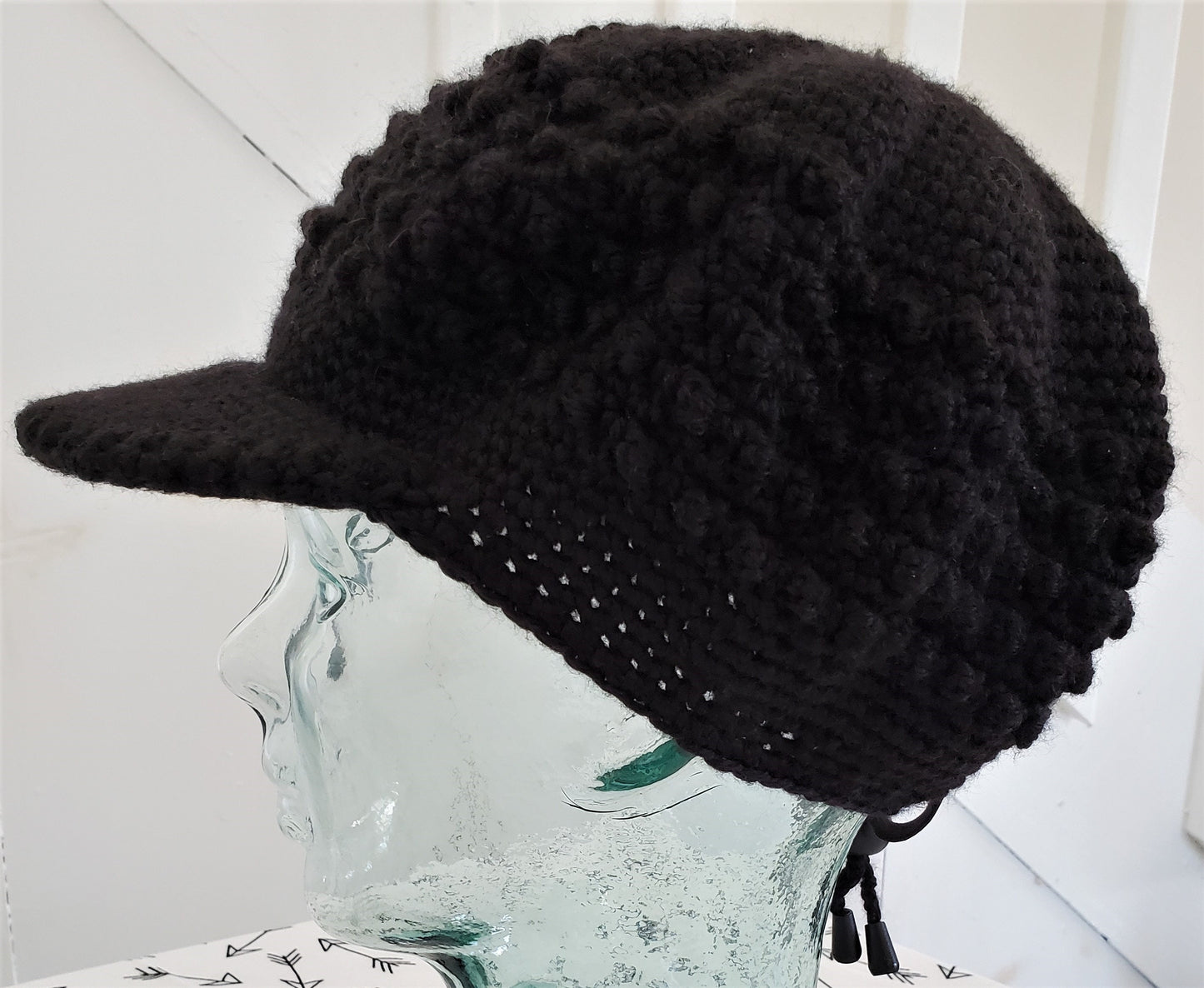 Black popcorn stitch cap with brim and toggle