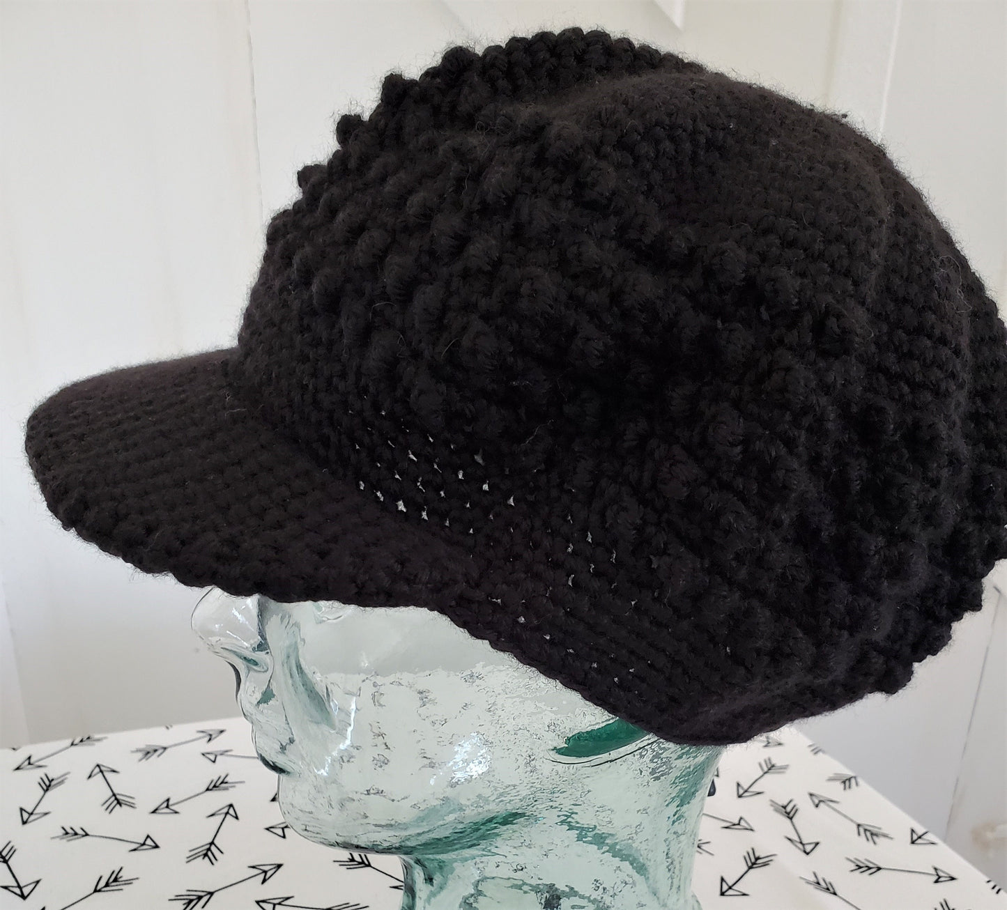 Black popcorn stitch cap with brim and toggle